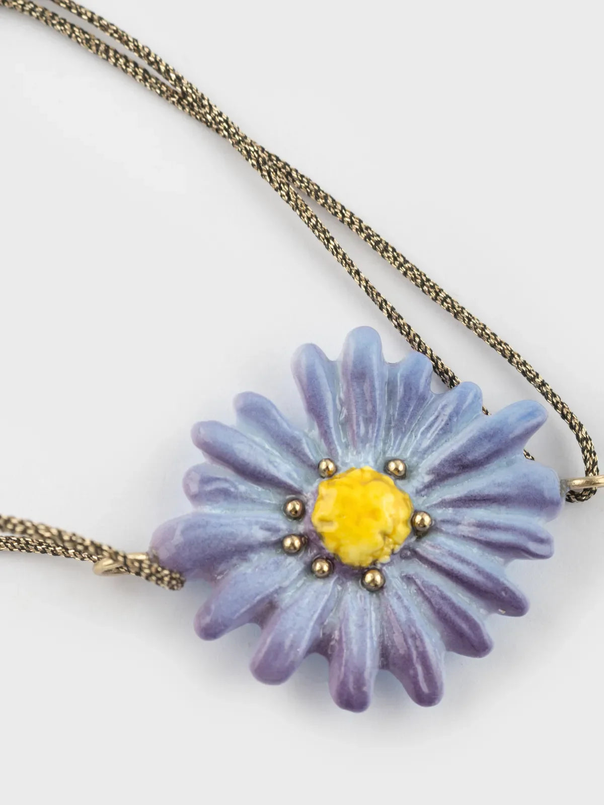 Iridescent cord bracelet with blue anemone flower