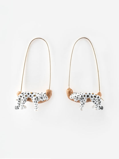 White leopard drop earrings on a branch