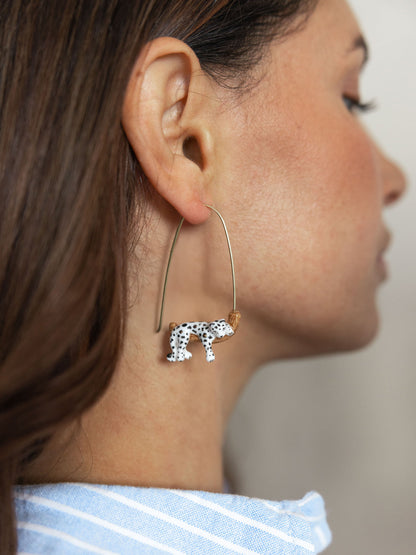 White leopard drop earrings on a branch