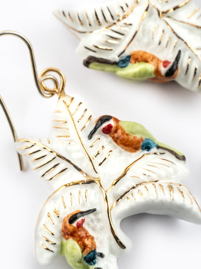 Boucles d'oreilles guêpiers d'Afrique sur palmiers blancs